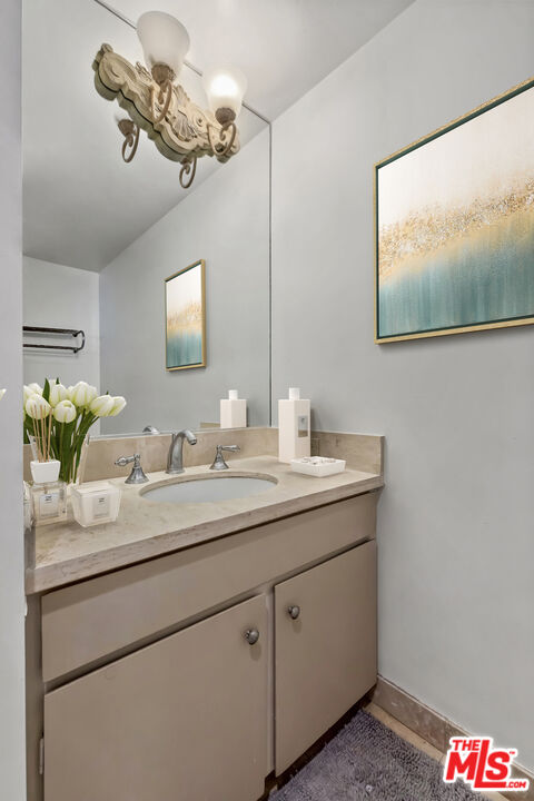2170 Century Park East, Unit 1507 Los Angeles, CA 90067 - Photo 10 of 17 a bathroom with a double vanity sink and a mirror