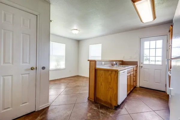 a utility room with sink dryer and washer