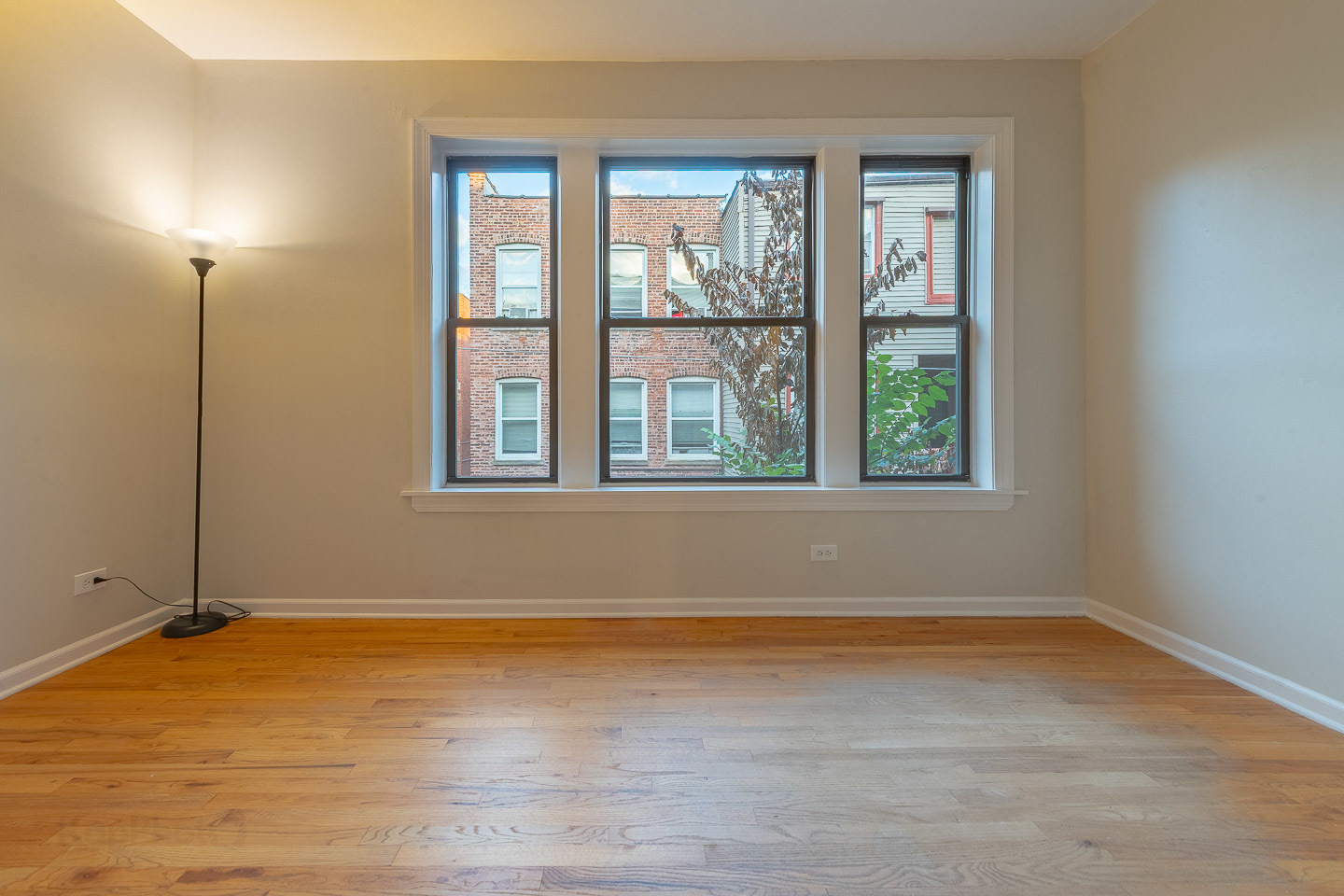 5223 South Drexel Avenue, Unit 2N Chicago, IL 60615 - Photo 18 of 27 wooden floor and window in an empty room