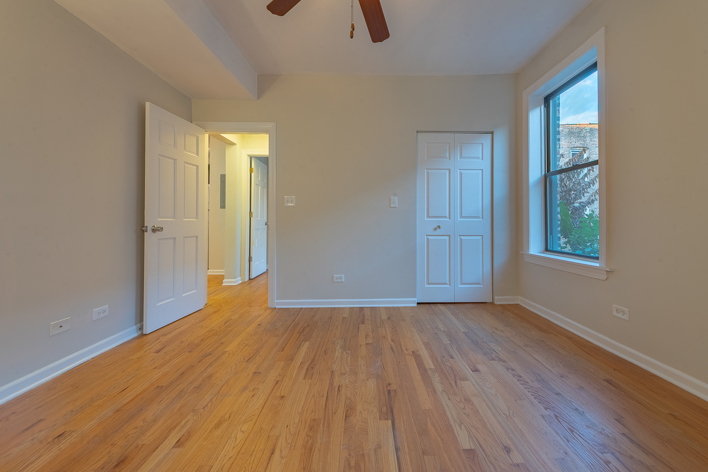 5223 South Drexel Avenue, Unit 2N Chicago, IL 60615 - Photo 21 of 27 a view of an empty room with wooden floor and a window