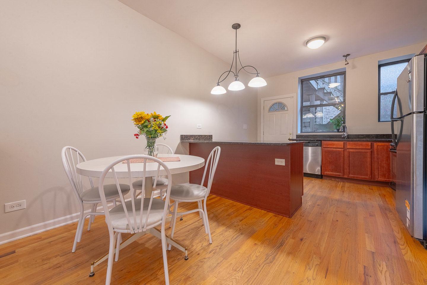 5223 South Drexel Avenue, Unit 2N Chicago, IL 60615 - Photo 7 of 27 a view of a dining room with furniture a chandelier and wooden floor