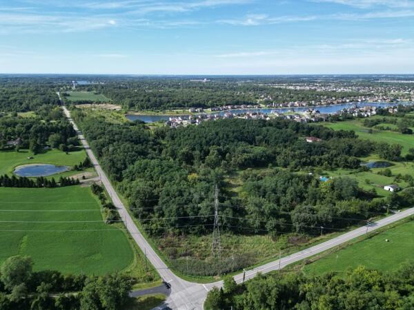a view of a city with lush green forest