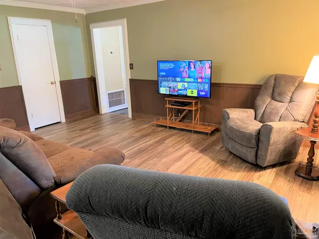 a living room with furniture and a flat screen tv