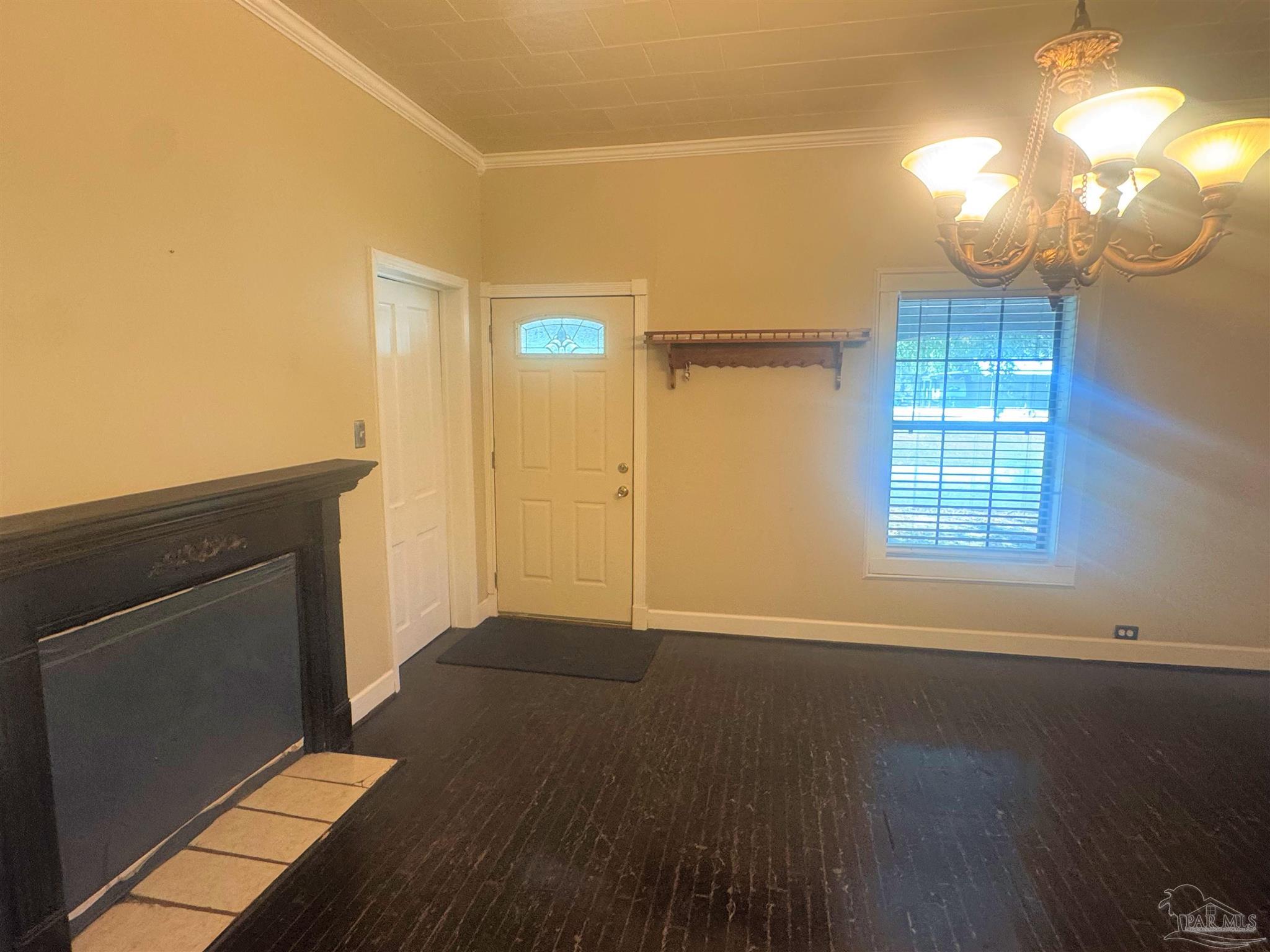 77 Hill Street Atmore, AL 36502 - Photo 15 of 30 an empty room with wooden floor mirror and windows