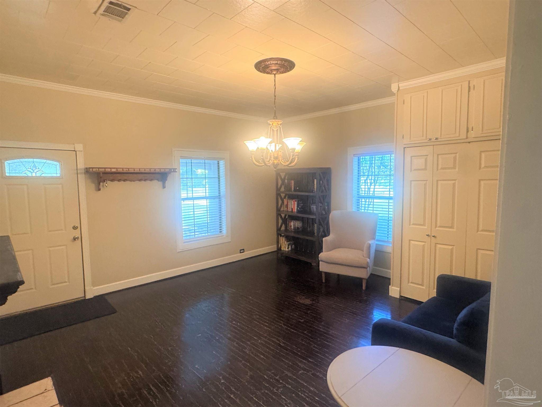77 Hill Street Atmore, AL 36502 - Photo 16 of 30 a living room with furniture a window and wooden floor