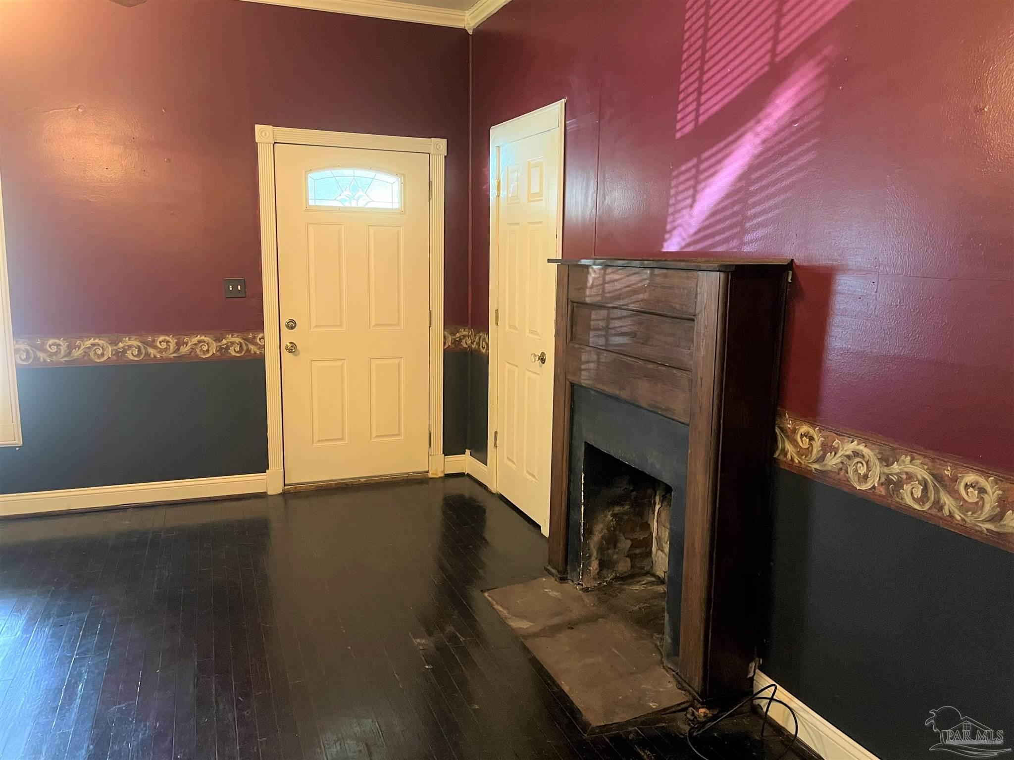 77 Hill Street Atmore, AL 36502 - Photo 21 of 30 a view of an empty room with wooden floor and a fireplace