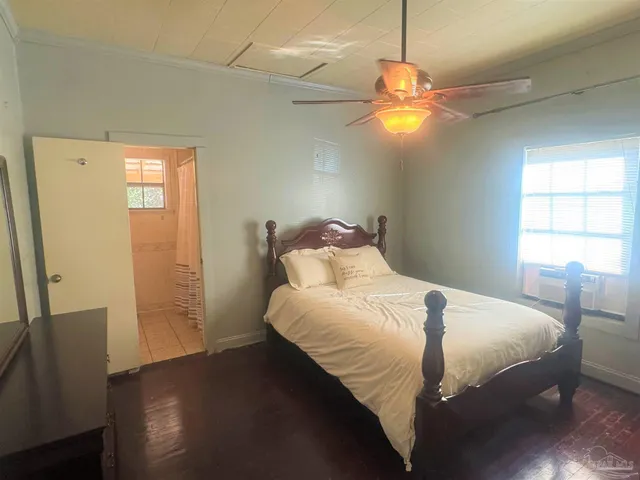 a bedroom with a bed and a window