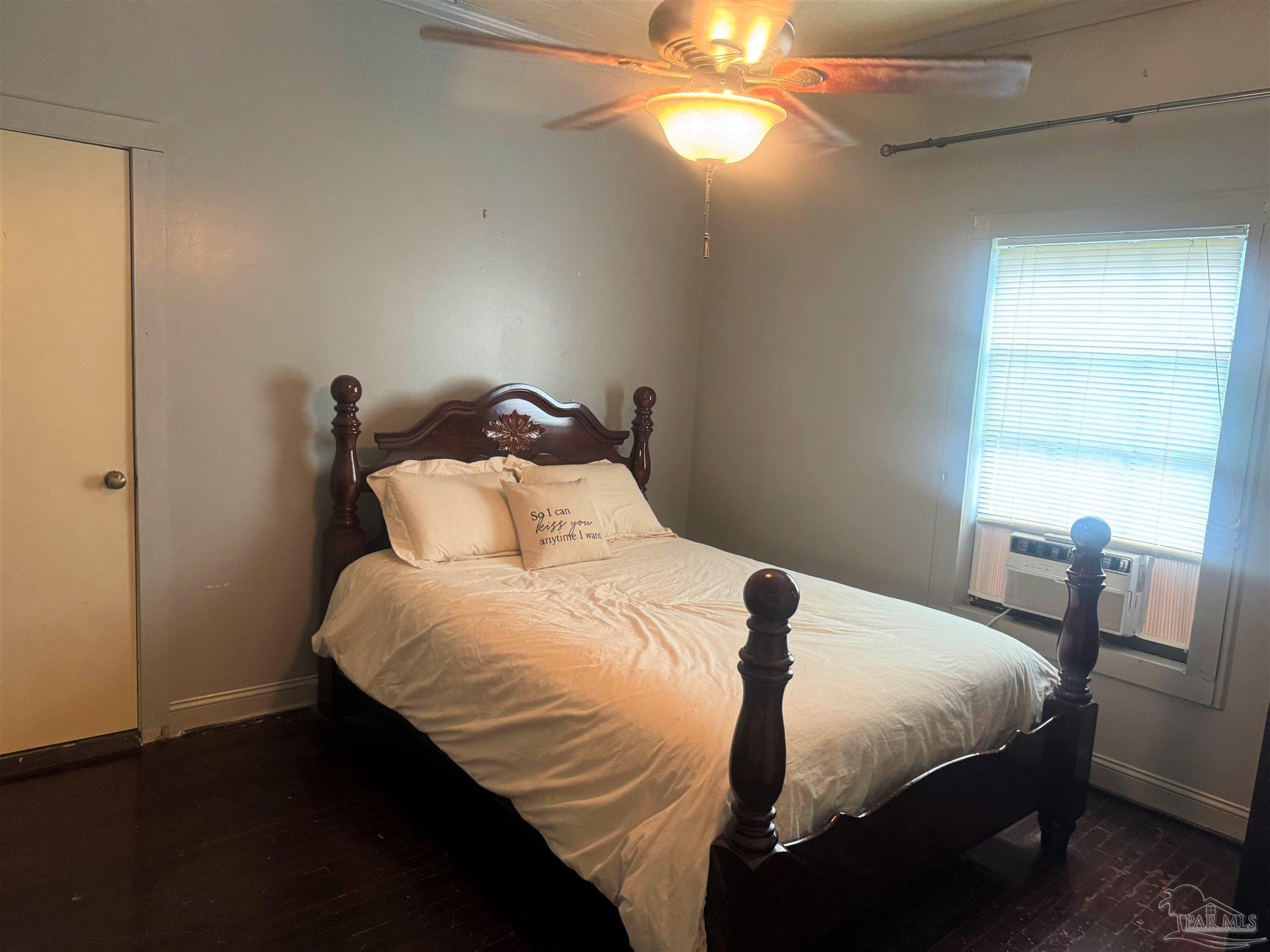 77 Hill Street Atmore, AL 36502 - Photo 24 of 30 a bedroom with a bed and a chandelier