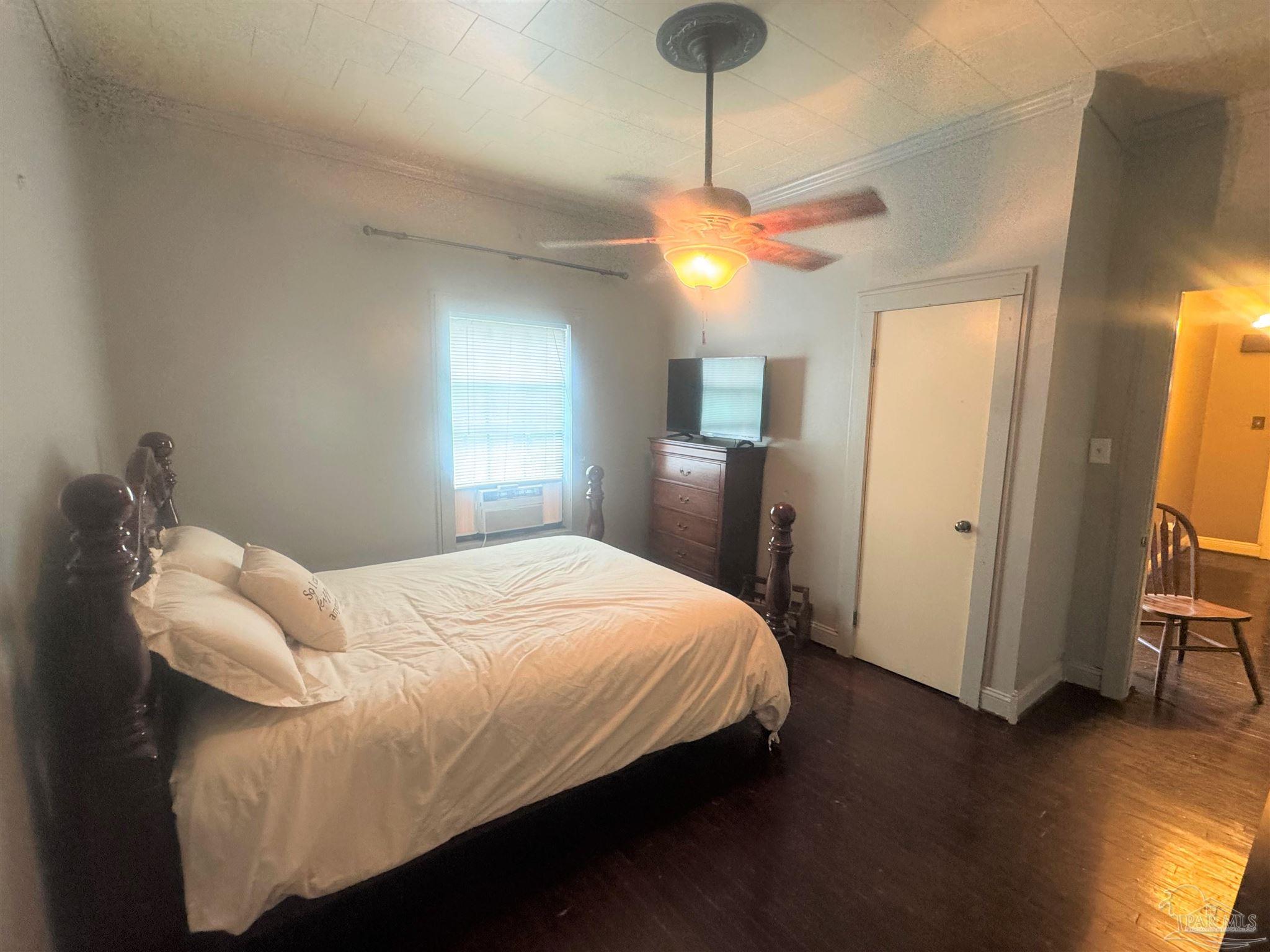 77 Hill Street Atmore, AL 36502 - Photo 25 of 30 a bedroom with a bed and wooden floor