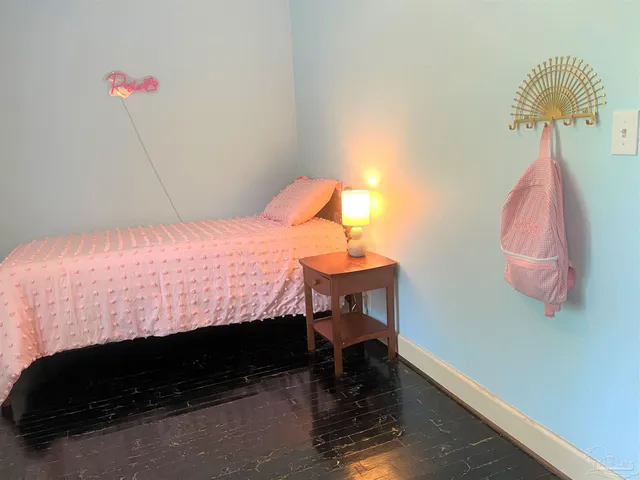 a bedroom with a bed and a dresser