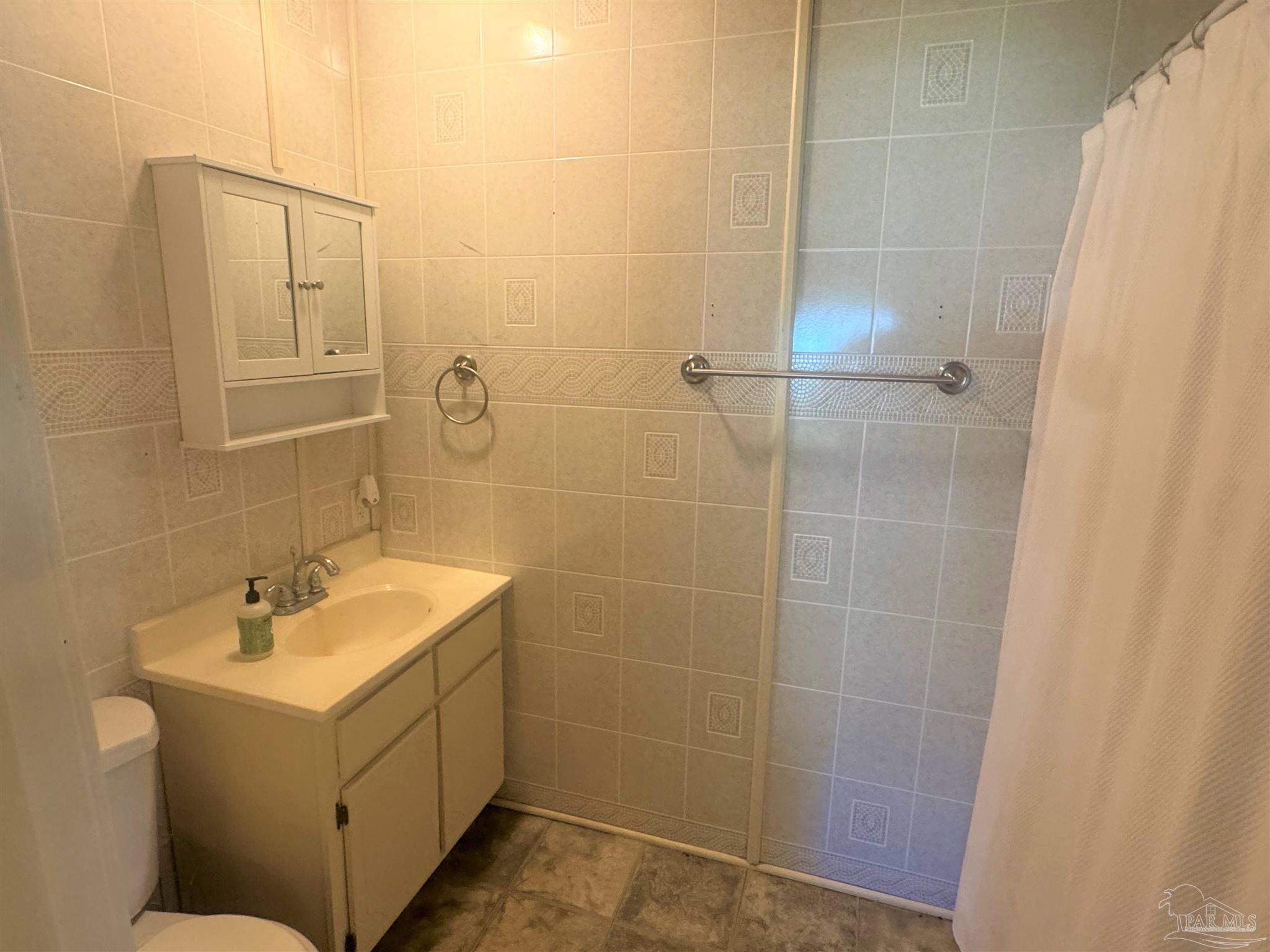 77 Hill Street Atmore, AL 36502 - Photo 29 of 30 a bathroom with a sink toilet and shower