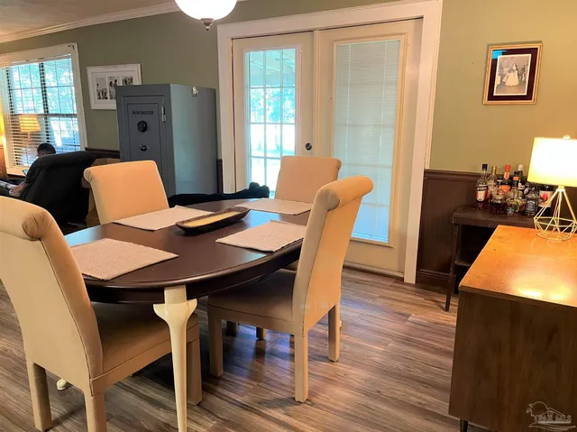 a view of a dining room with furniture window and wooden floor