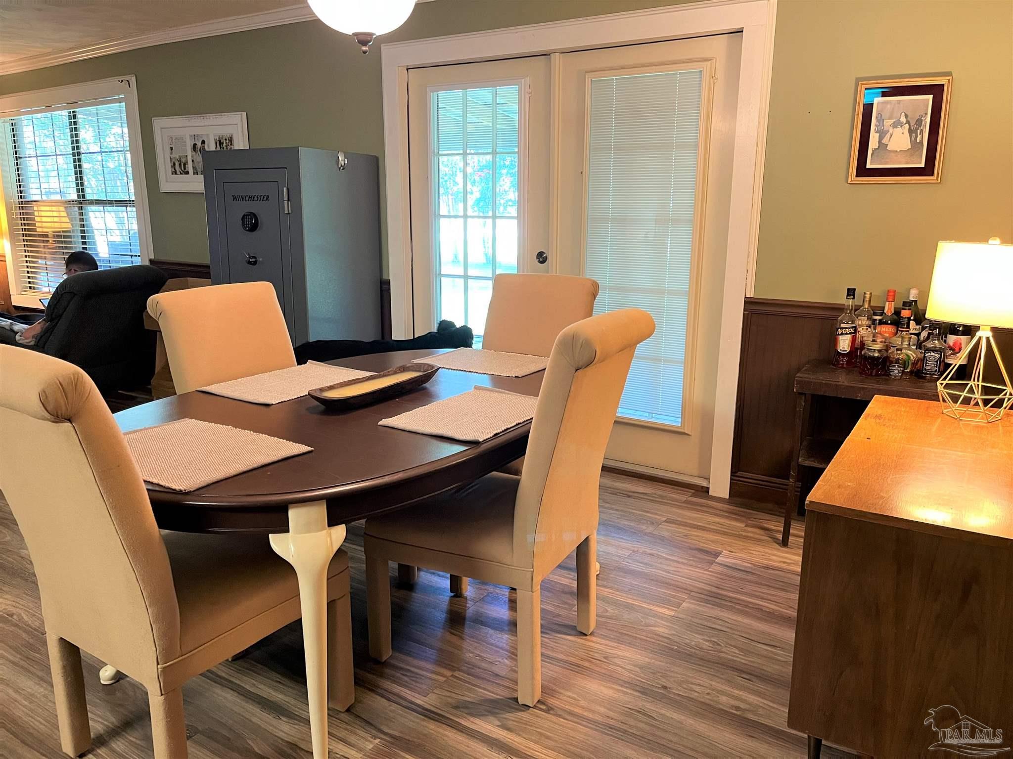 77 Hill Street Atmore, AL 36502 - Photo 10 of 30 a view of a dining room with furniture window and wooden floor