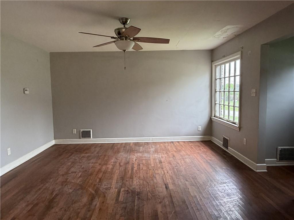 1146 Franklin Road Jackson Center, PA 16133 - Photo 10 of 19 an empty room with wooden floor fan and windows