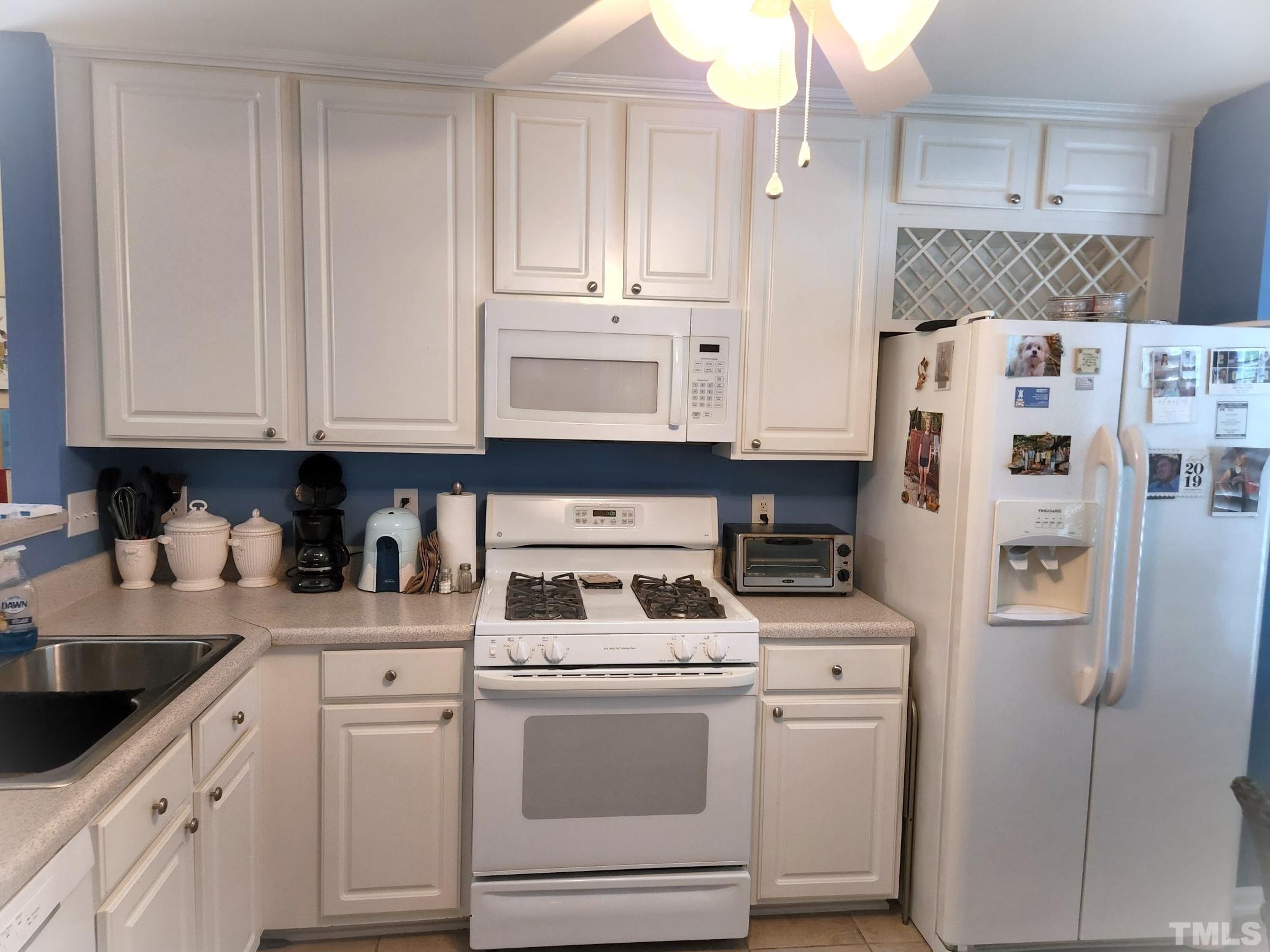 307 Latta Circle Durham, NC 27712 - Photo 16 of 37 a kitchen with stainless steel appliances granite countertop a refrigerator sink and white cabinets