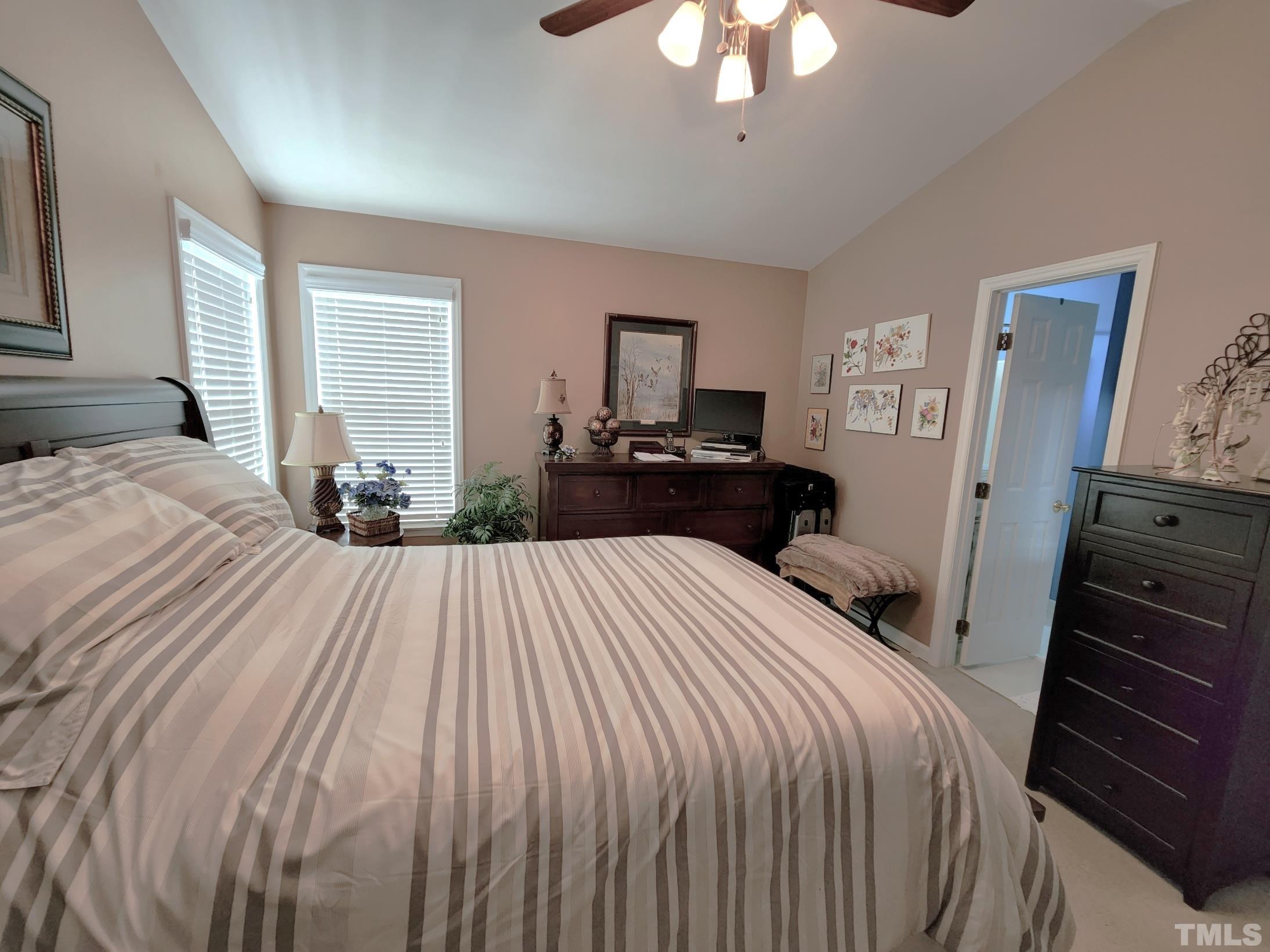 307 Latta Circle Durham, NC 27712 - Photo 18 of 37 a bedroom with a bed and a chandelier