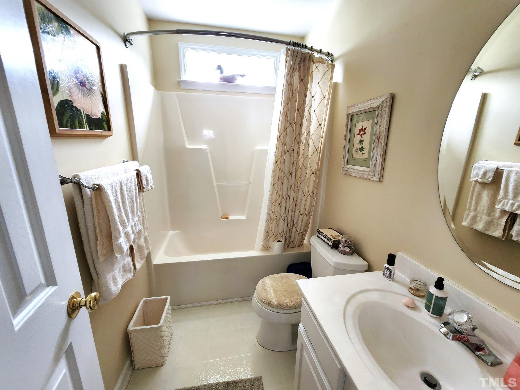 307 Latta Circle Durham, NC 27712 - Photo 24 of 37 a bathroom with a sink a toilet and a mirror