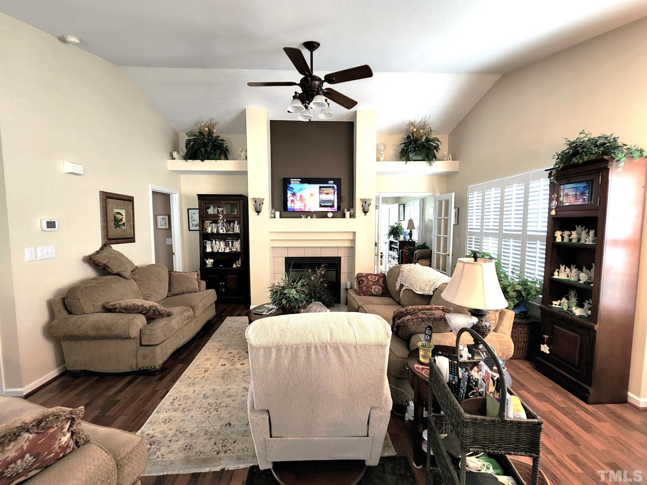 307 Latta Circle Durham, NC 27712 - Photo 7 of 37 a living room with furniture a fireplace and a flat screen tv
