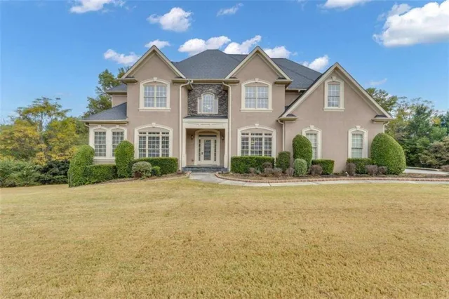 a front view of a house with a yard and garage