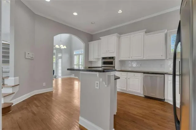 wooden floor in an empty room with a staircase