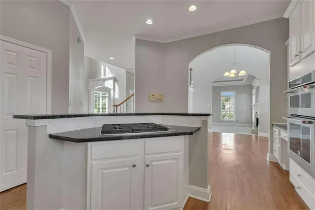 a view of an empty room with a fireplace and a window