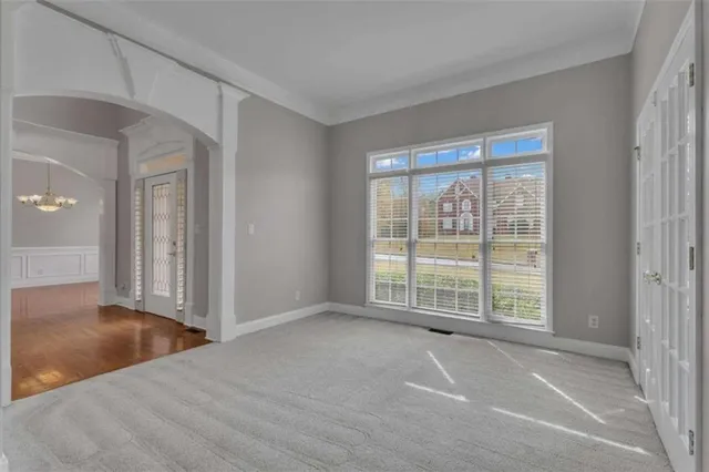 a view of an empty room with a fireplace and a window