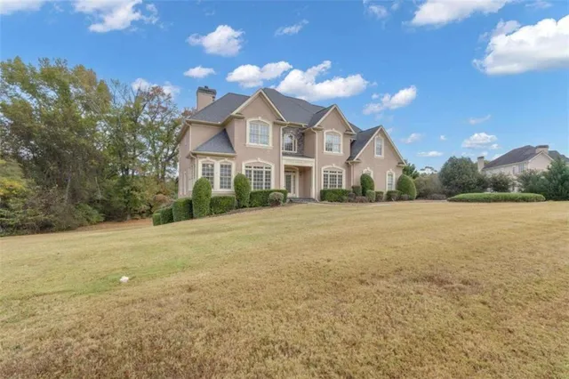 a kitchen with white cabinets and refrigerator