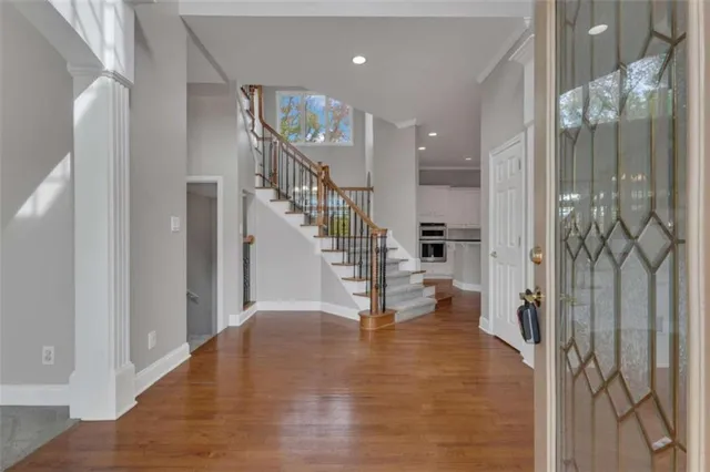 a view of kitchen with wooden floor and electronic appliances