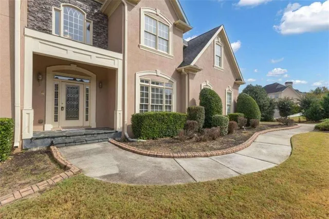 a kitchen with stainless steel appliances granite countertop a sink stove oven and white cabinets