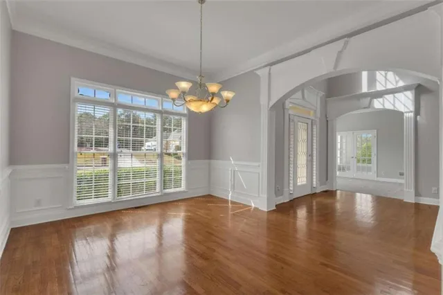 a kitchen with stainless steel appliances granite countertop a refrigerator a stove and a sink