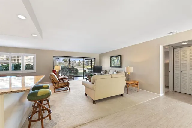 a spacious bathroom with a granite countertop sink a toilet and shower