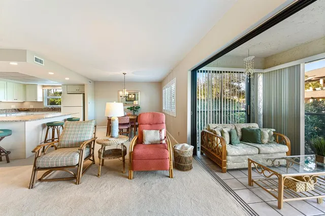 a bedroom with a bed and a lamp on dresser