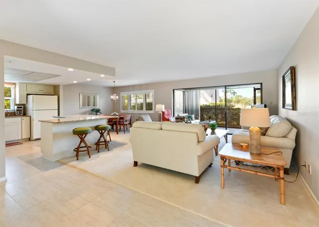 a living room filled with furniture and a floor to ceiling window