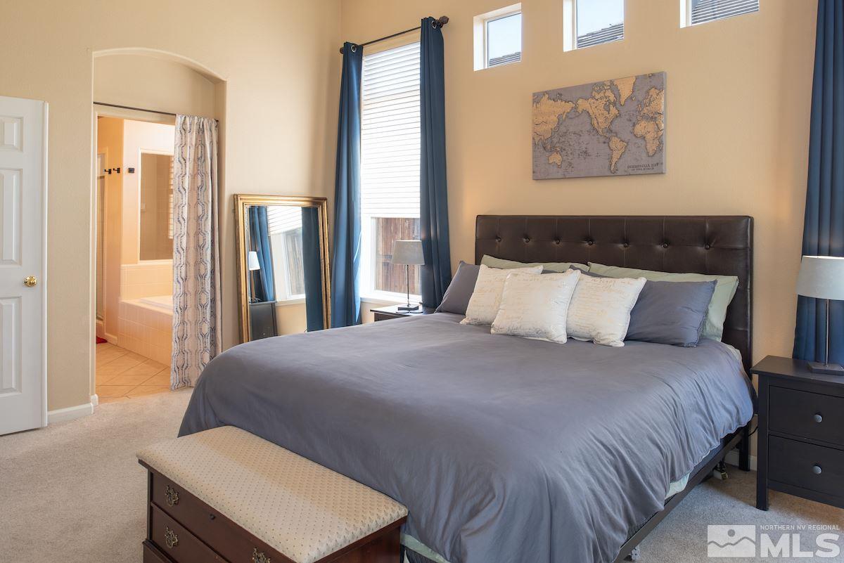 9917 Rio Bravo Drive Reno, NV 89521 - Photo 11 of 36 a bedroom with a bed and wooden floor