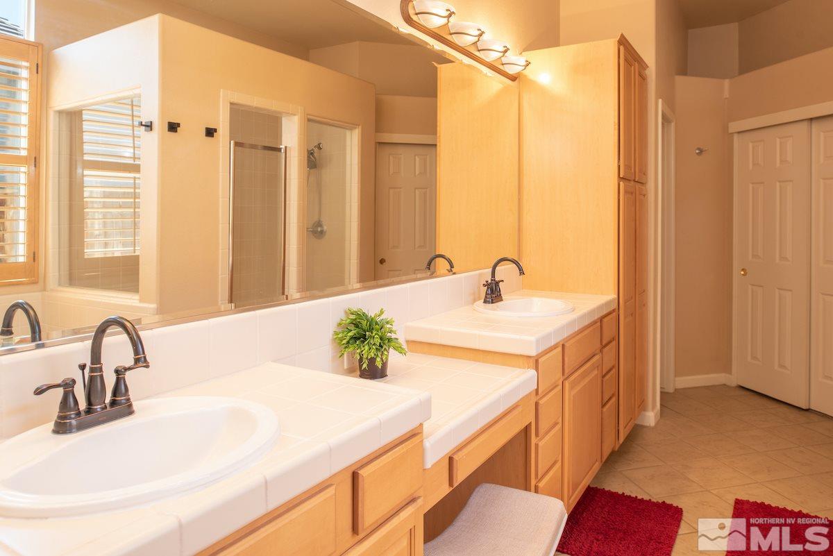 9917 Rio Bravo Drive Reno, NV 89521 - Photo 12 of 36 a bathroom with a sink and a mirror