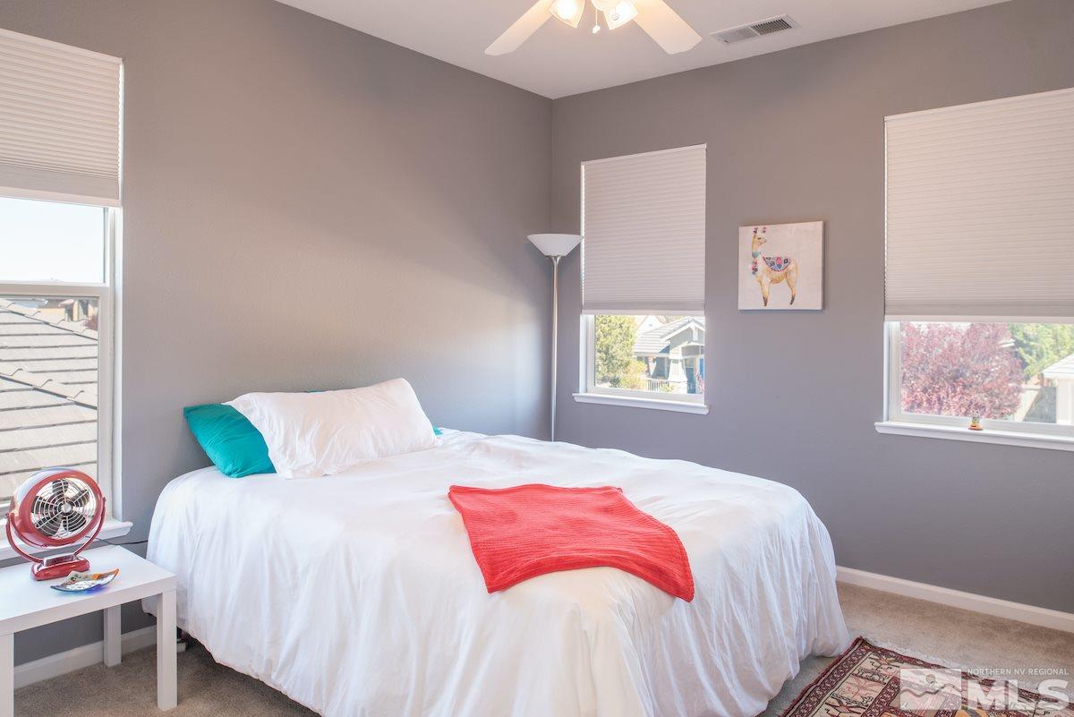 9917 Rio Bravo Drive Reno, NV 89521 - Photo 14 of 36 a bedroom with a bed and a window