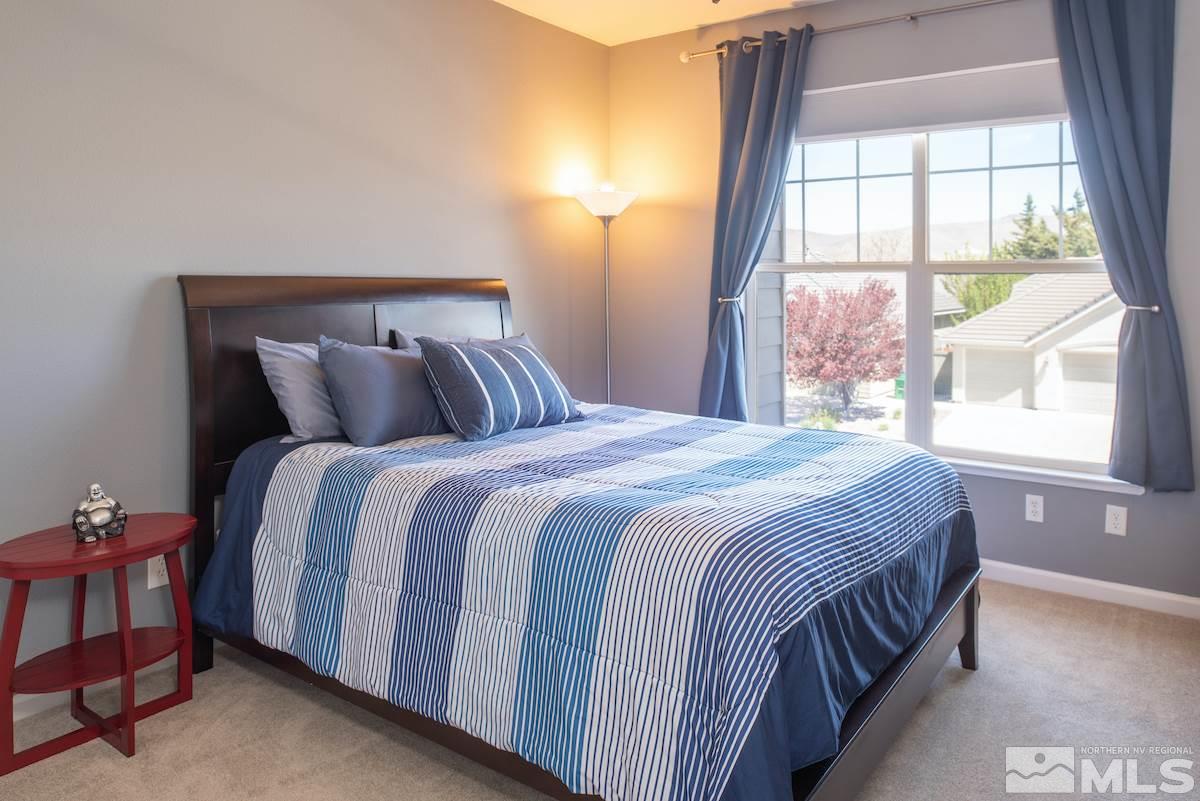 9917 Rio Bravo Drive Reno, NV 89521 - Photo 15 of 36 a bedroom with a bed and window