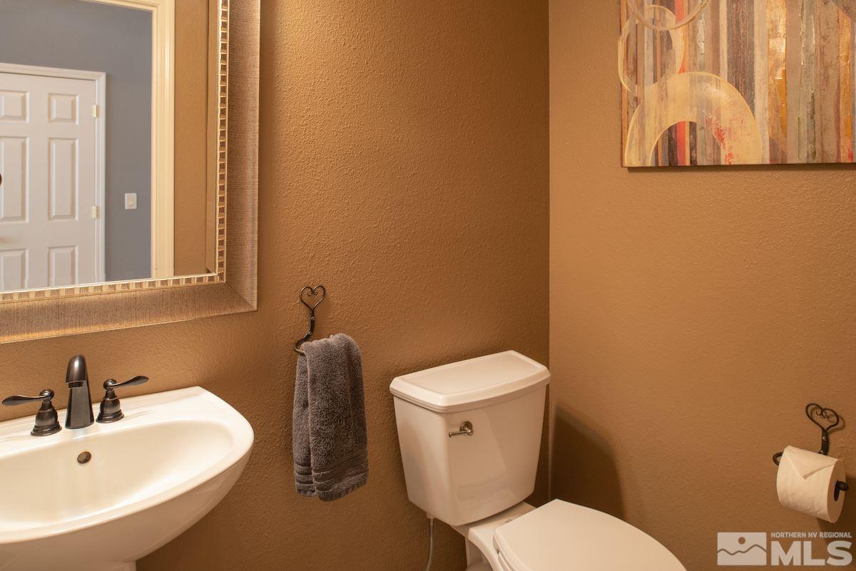 9917 Rio Bravo Drive Reno, NV 89521 - Photo 20 of 36 a white toilet sitting next to a bathroom sink