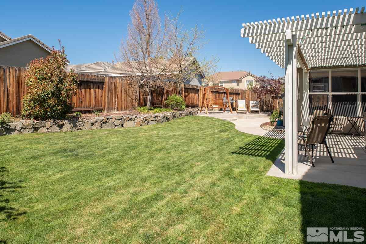 9917 Rio Bravo Drive Reno, NV 89521 - Photo 23 of 36 a view of a house with a yard patio and fire pit