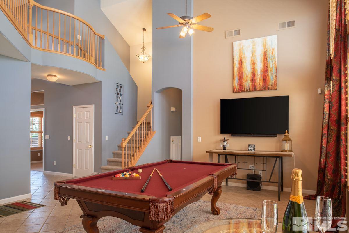 9917 Rio Bravo Drive Reno, NV 89521 - Photo 3 of 36 a living room with furniture a flat screen tv and a window