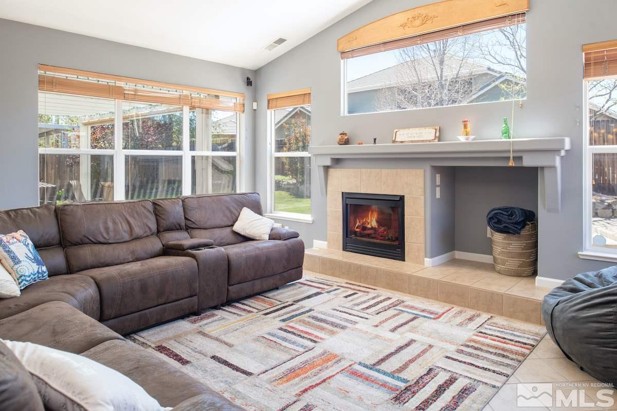 9917 Rio Bravo Drive Reno, NV 89521 - Photo 5 of 36 a living room with furniture a window and a fireplace