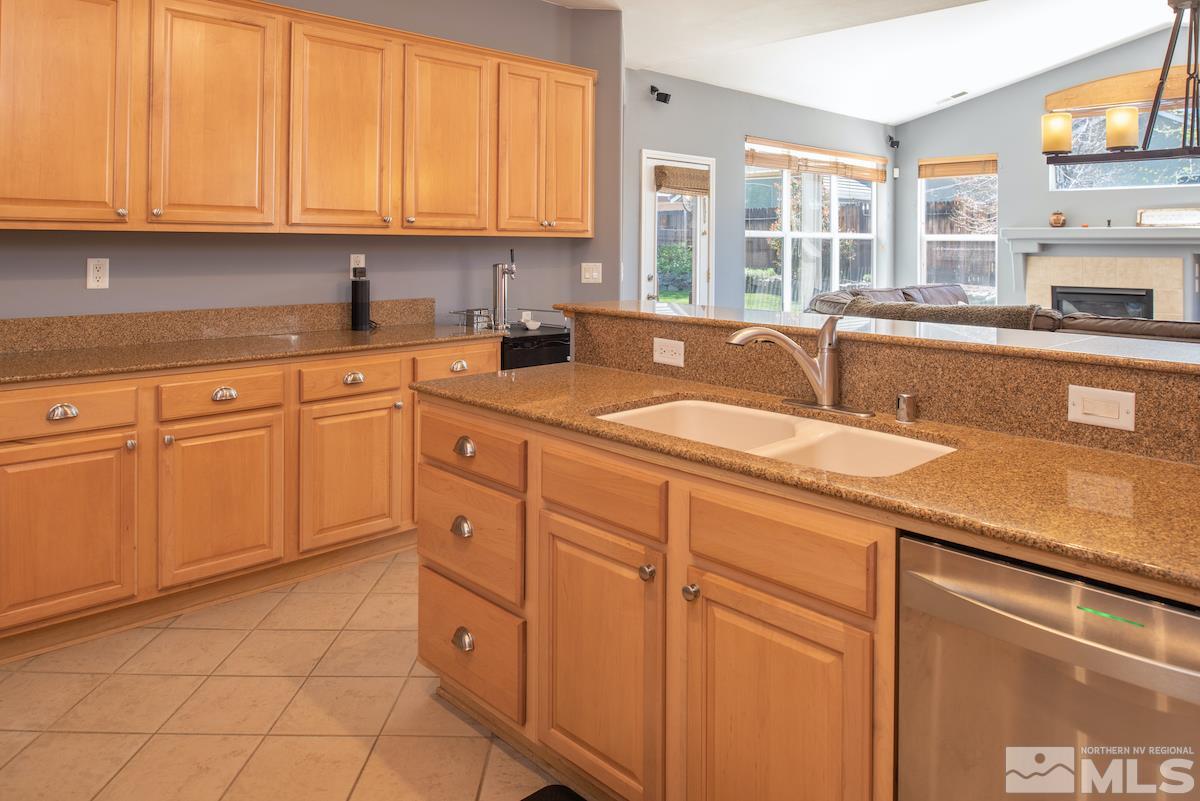 9917 Rio Bravo Drive Reno, NV 89521 - Photo 9 of 36 a kitchen with stainless steel appliances granite countertop a sink and cabinets