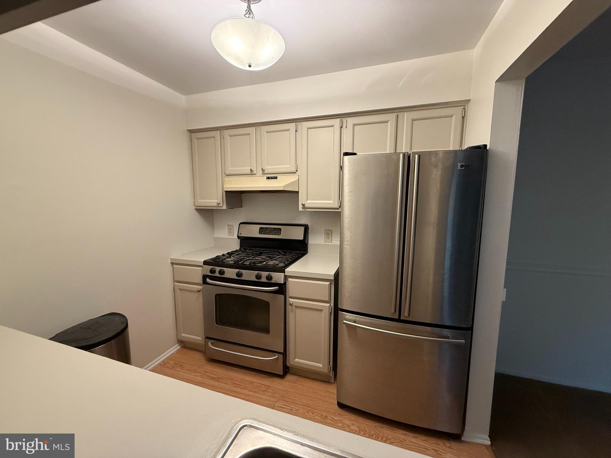 36 Gena Court Hamilton, NJ 08690 - Photo 3 of 15 a kitchen with stainless steel appliances a refrigerator a stove and white cabinets