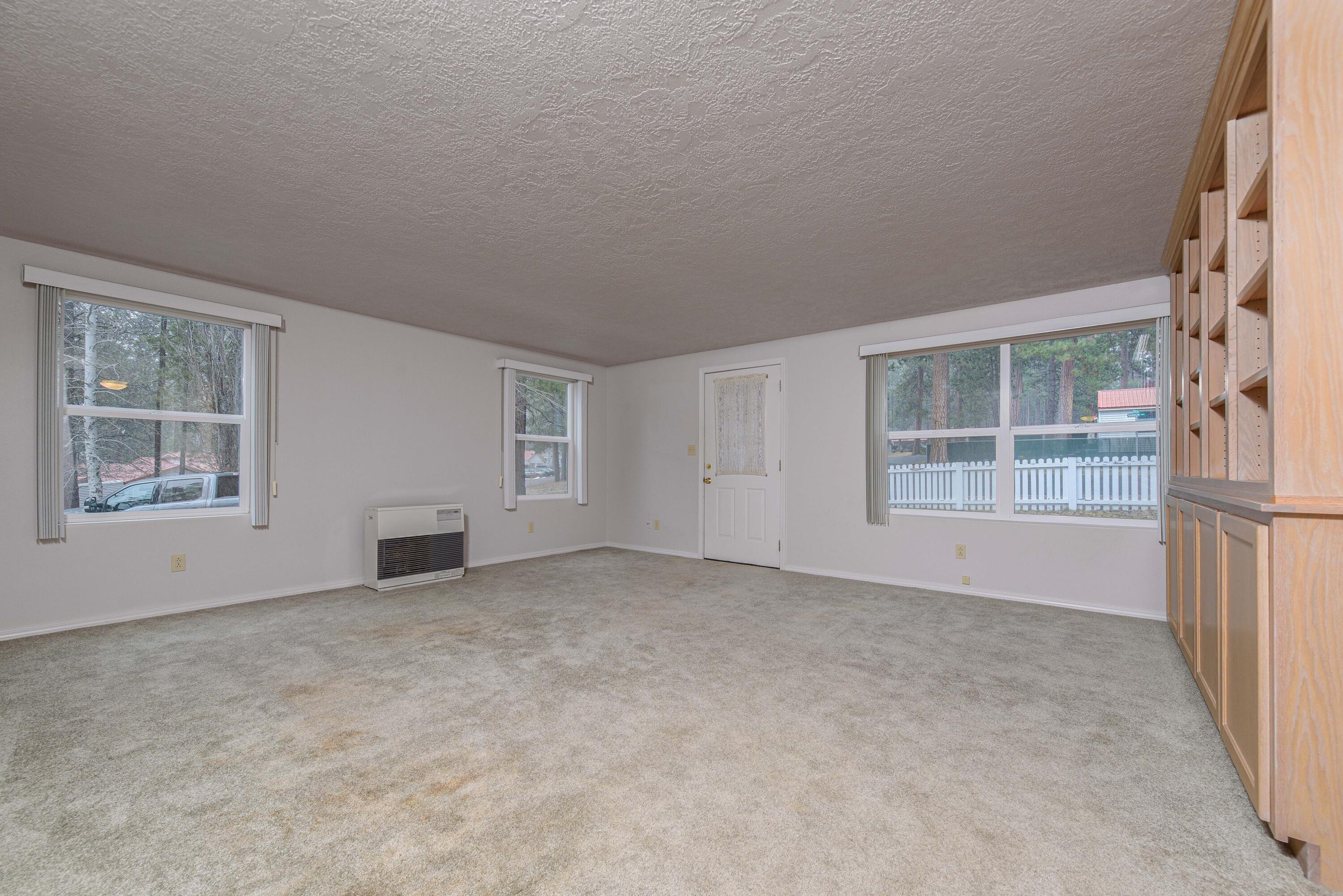 138722 Rhododendron Street Gilchrist, OR 97737 - Photo 13 of 36 an empty room with windows