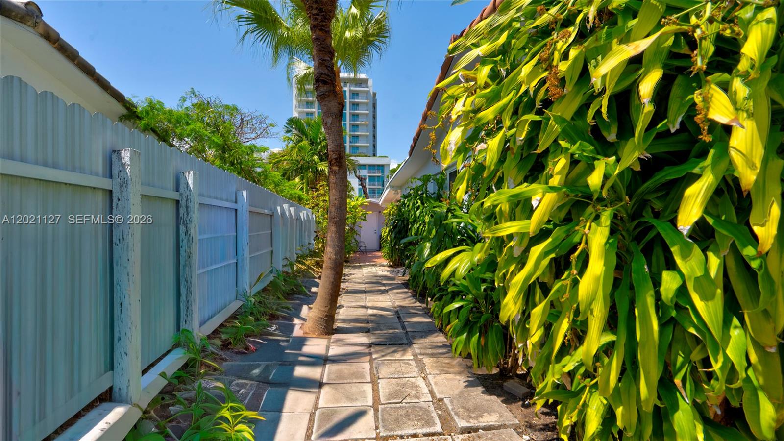 3611 Southwest 23rd Street Miami, FL 33145 - Photo 35 of 56 3613- gated side access /pathway to back yard from the front right side of the property