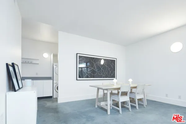 a dining room with furniture and a painting