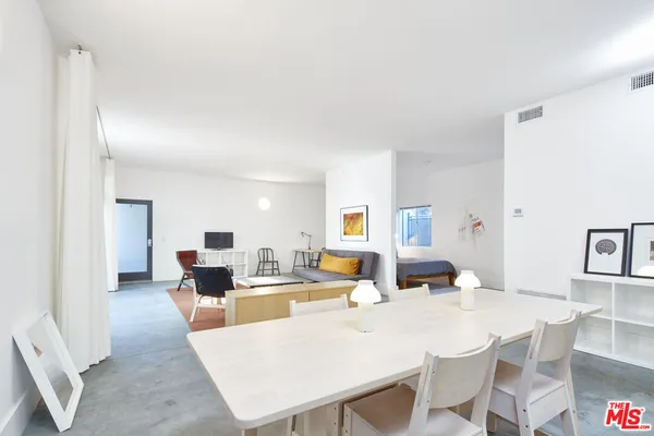 a living room with furniture a dining table and chairs