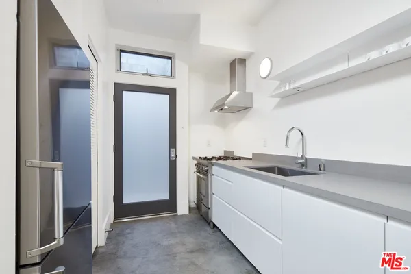 a kitchen with stainless steel appliances granite countertop a sink and cabinets