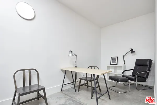 a dining room with furniture and a mirror