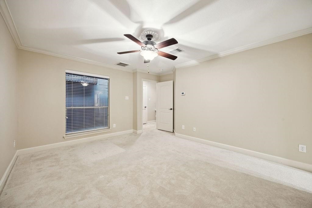 5407 Lillian Street Houston, TX 77007 - Photo 29 of 38 an empty room with chandelier fan and windows